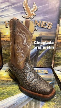 a pair of cowboy boots in front of a box