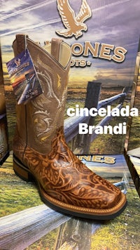 a pair of cowboy boots in front of a box