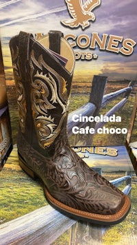 a pair of cowboy boots on display in a store